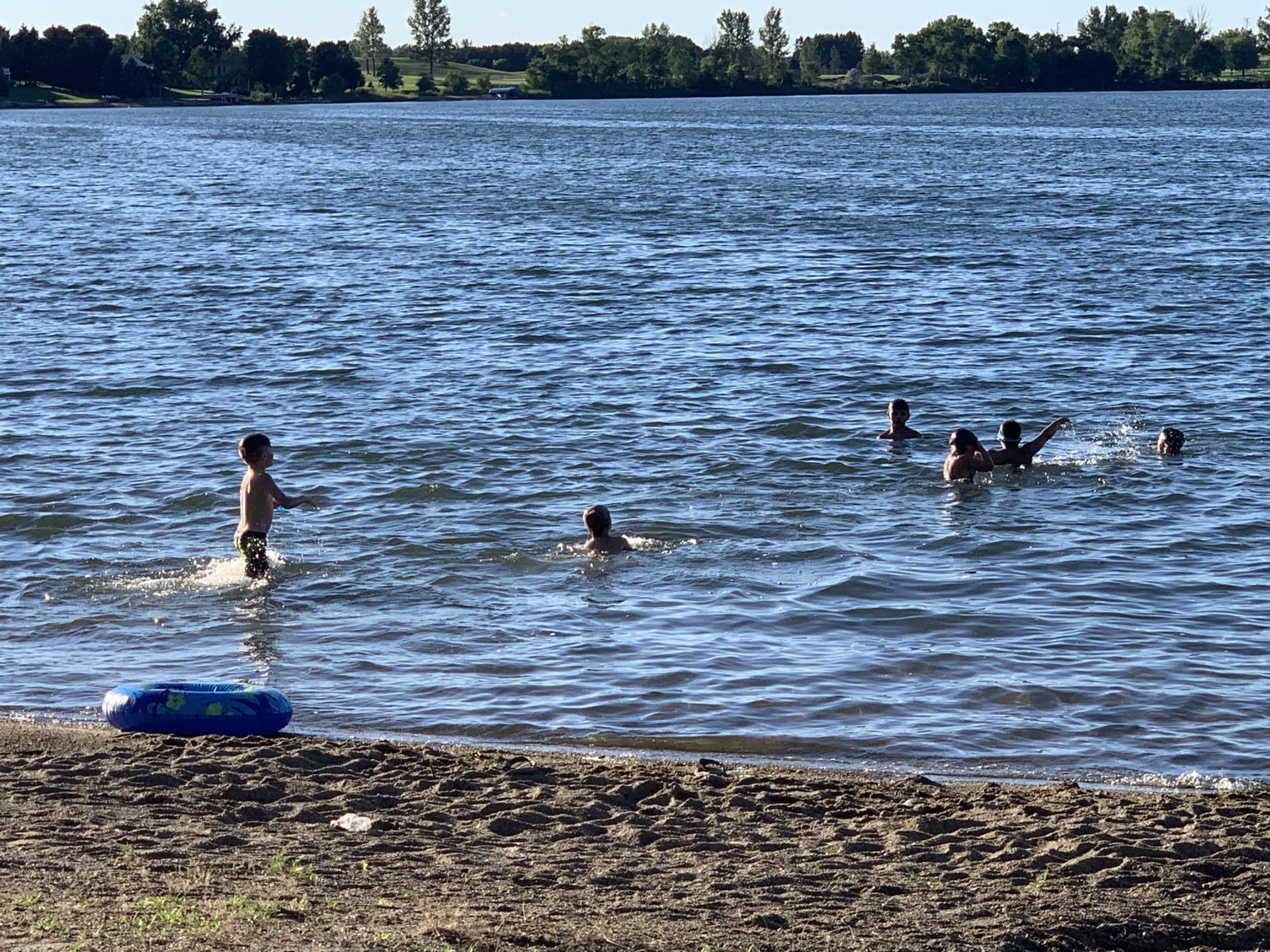 Kids swimming at a lake