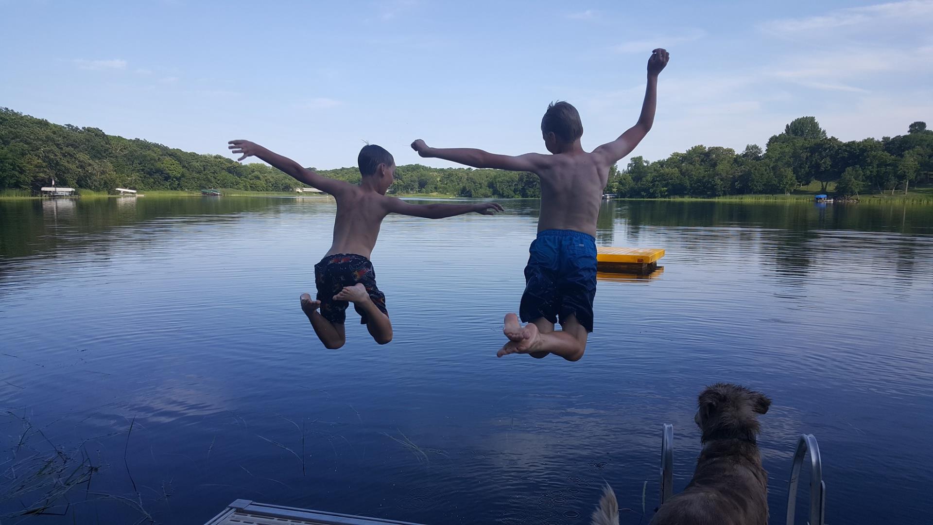 Kids jumping into a lake